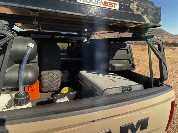 Overlanding truck bed: Roofnest tent, Dometic fridge, water tank, and spare tire. Perfect for your next rv rental adventure.. Dodge Dodge 1 Ton Pu 2018