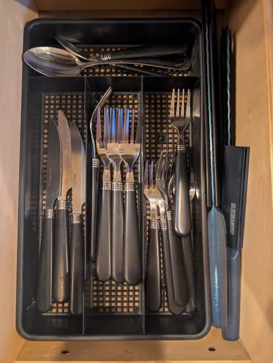 Stay organized in your RV rental with this kitchen drawer setup, neatly storing forks, knives, spoons, and other utensils.. Thor Four Winds 2021