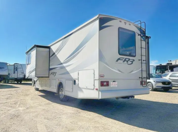 Forest River FR3 RV rental, a large motorhome with an extended slide-out, parked outdoors on a sunny day.. FR3 FR3 Motorhome 2017