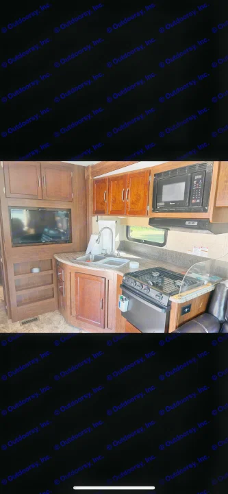 This RV rental features a well-equipped kitchen with a sink, stove, microwave, and a TV in the living area.. Forest River Coachmen Pursuit 2017