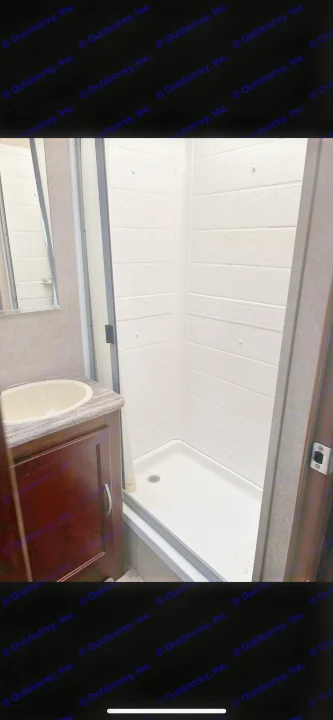 Compact RV rental bathroom featuring a clean shower stall, vanity, and sink, ideal for your next trip.. Forest River Coachmen Pursuit 2017