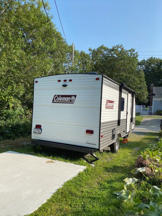 This MA Coleman RV rental (Dutchmen travel trailer) is securely parked with jacks down, ready for camping adventures.. Coleman Lantern 17B 2024