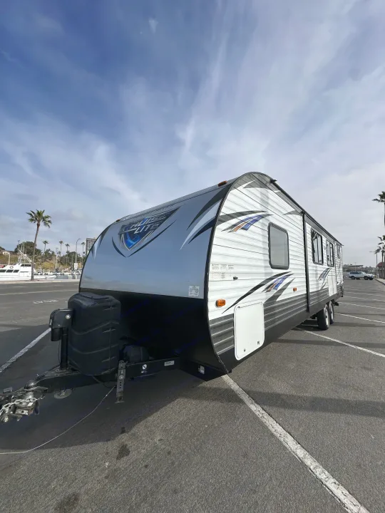 Spacious Forest River Cruise Lite travel trailer RV rental, ready for adventure! Parked on a sunny day near a marina.. Forest River Salem Cruise Lite 2019