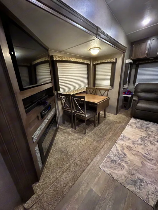 Spacious RV rental interior with dining area, TV, and recliners for a comfortable stay.. Forest River Flagstaff Super Lite 2019