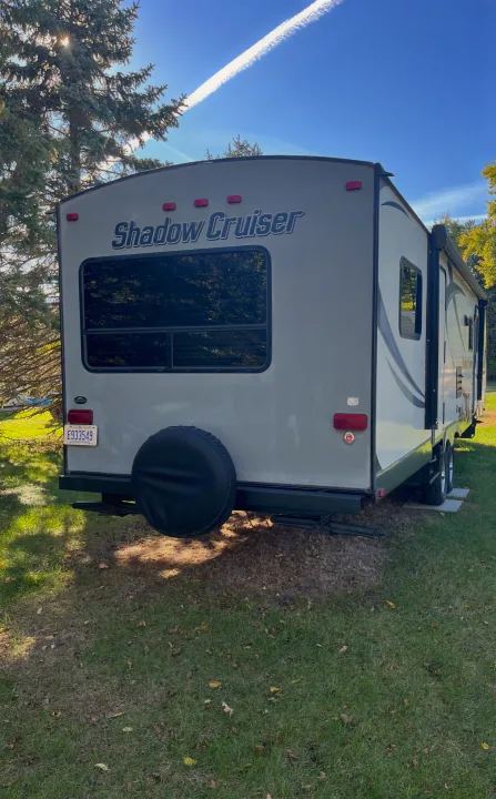 Rear view of a gray Shadow Cruiser travel trailer parked on grass, suitable for your next rv rental camping trip.. Cruiser RV Shadow Cruiser 2015