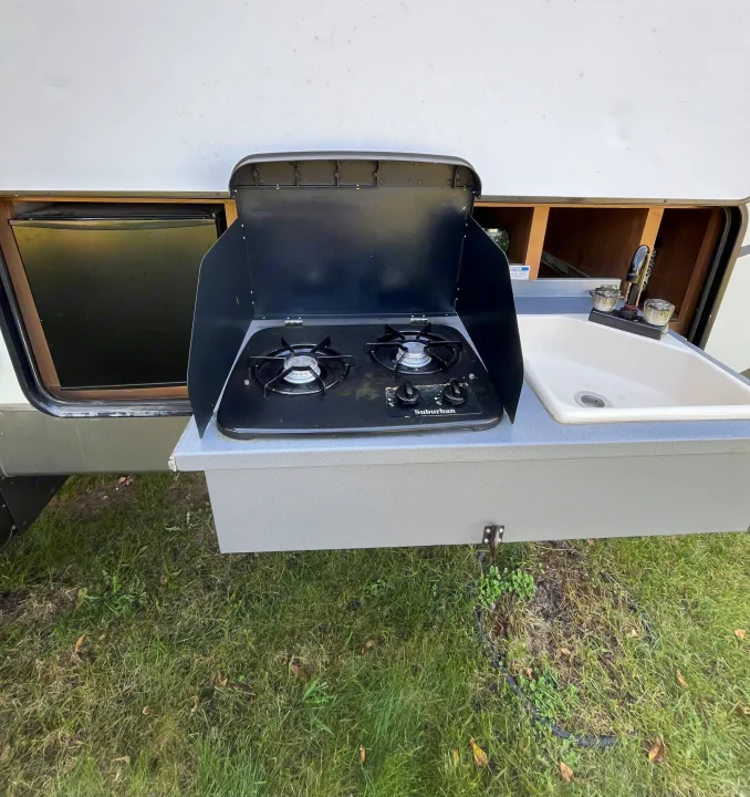 RV rental: Outdoor kitchen with a two-burner stove, sink, and fridge for easy camp cooking.. Cruiser RV Shadow Cruiser 2015