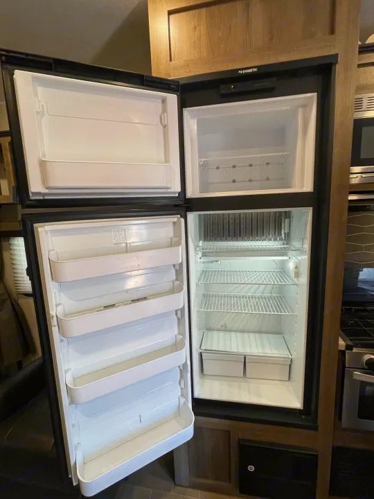 Clean, empty Dometic RV refrigerator & freezer, ready for your rv rental adventure supplies. Spacious interior.. Palomino Puma 2021