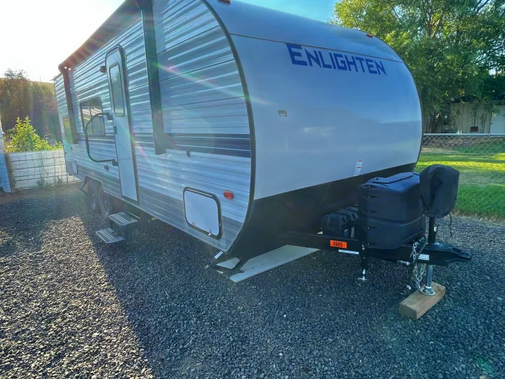 This "ENLIGHTEN" travel trailer RV is set up on gravel, ready for your next rv rental adventure.. Gulf Stream Enlighten 2021