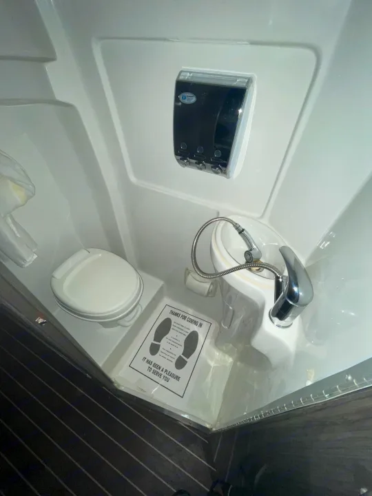 RV rental's space-saving wet bath: a toilet, sink with shower hose, and dispenser are neatly arranged for convenience.. Airstream Interstate 2015