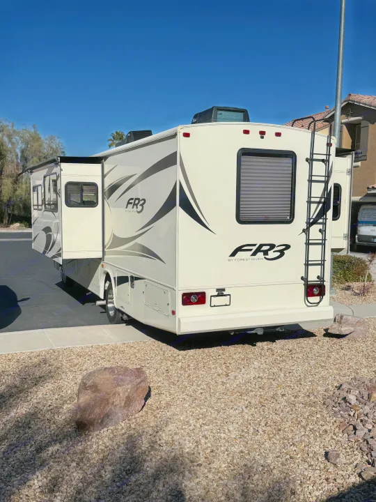 Cream-colored Forest River FR3 RV rental, with slide-outs extended, parked on a sunny day.. FR3 FR3 Motorhome 2018
