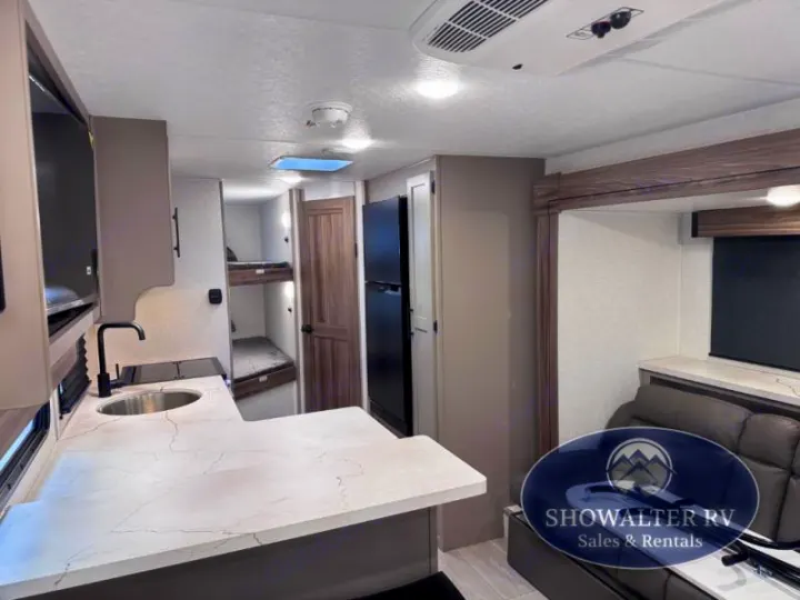 Spacious RV rental interior featuring a kitchen, bunk beds, and a comfortable living area.. K-Z Manufacturing Connect Mini 231BH 2025