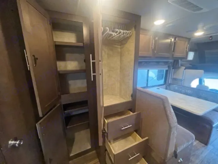 Ample storage and a dinette in this RV rental interior, featuring cabinets, shelves, and drawers for a comfortable stay.. Adventurer Adventurer Motorhome 2017