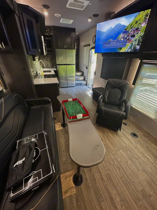 Spacious rv rental interior features a full kitchen, comfy living space with TV, and a tabletop Binho game.. Eclipse Recreational Vehicles Attitude 2020