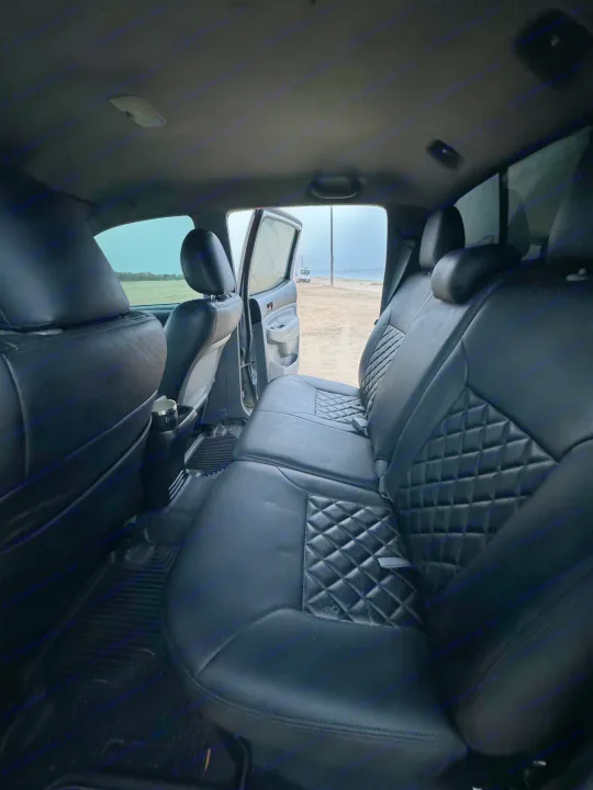 Comfortable truck back seats (quilted leather) looking out to a sandy beach. Great for trips; an RV rental awaits!. Adventurer 2015 Tacoma 2024