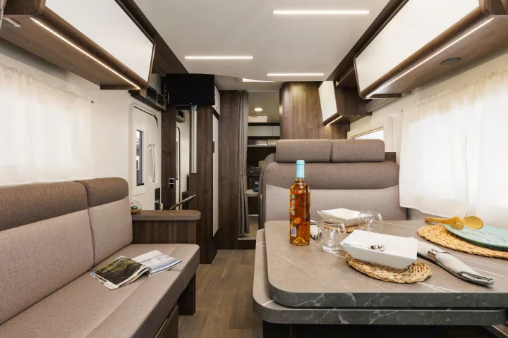 Experience comfort in this RV rental! Features a dining area, cozy lounge seating, and bright interior for enjoyable road trips.. Benimar Tessoro 463UP 2025