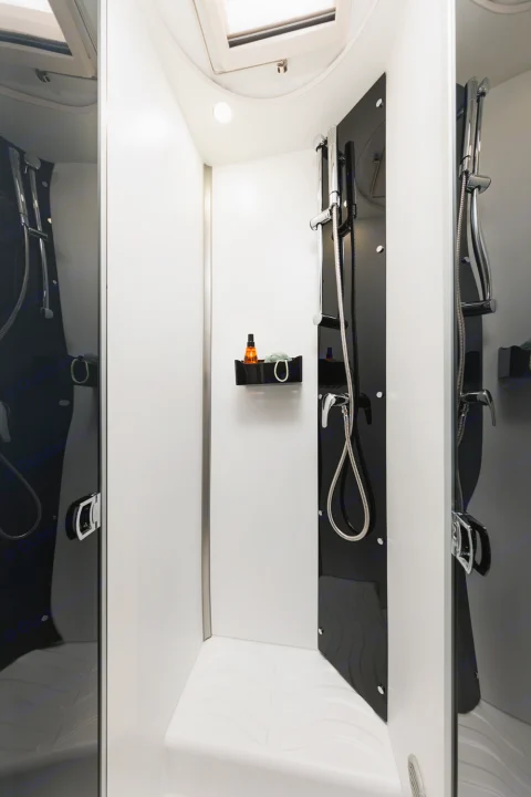 Step into a modern, compact RV shower with sleek black and white design, perfect for your RV rental adventure.. Benimar Tessoro 463UP 2025