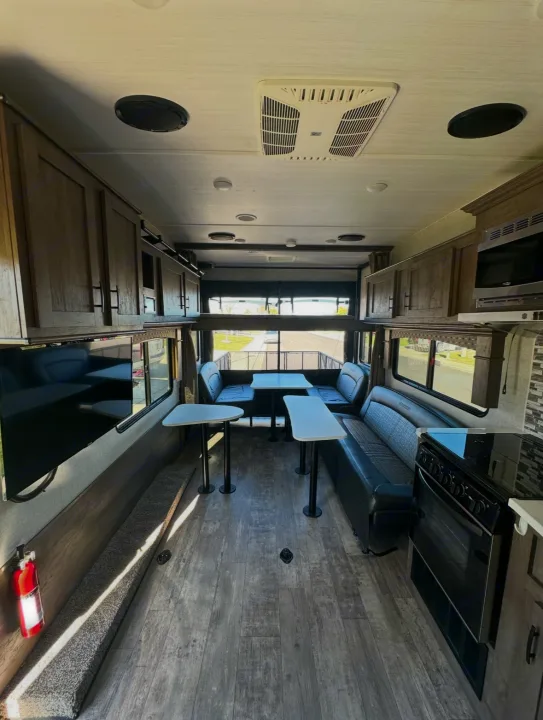 Inside a bright **rv rental**, featuring a kitchen, spacious dining/living area, and comfortable amenities, ideal for adventures.. Forest River Shockwave 2021