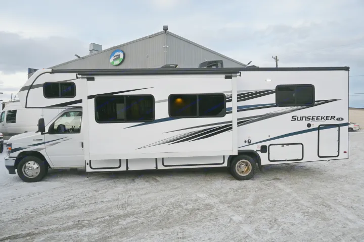 A white Sunseeker RV rental with an extended side-out, parked on snowy ground at an Alaska RV rental location.. Forest River Sunseeker - LE Series M-2850S 2024