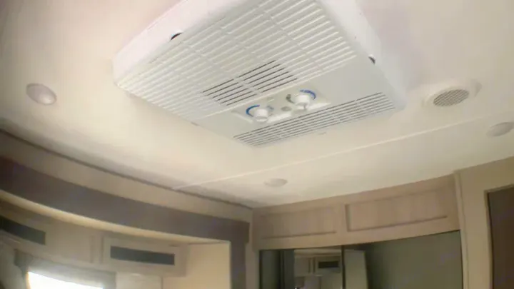 Central air conditioner unit, vents, and lights on the ceiling of an RV rental. Designed for comfort while traveling.. Coachmen Catalina 2021
