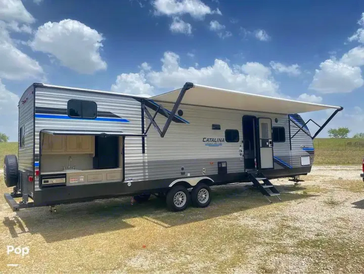 This travel trailer RV rental, featuring an extended awning & outdoor kitchen, is ready for your next camping trip.. Coachmen Catalina 2021