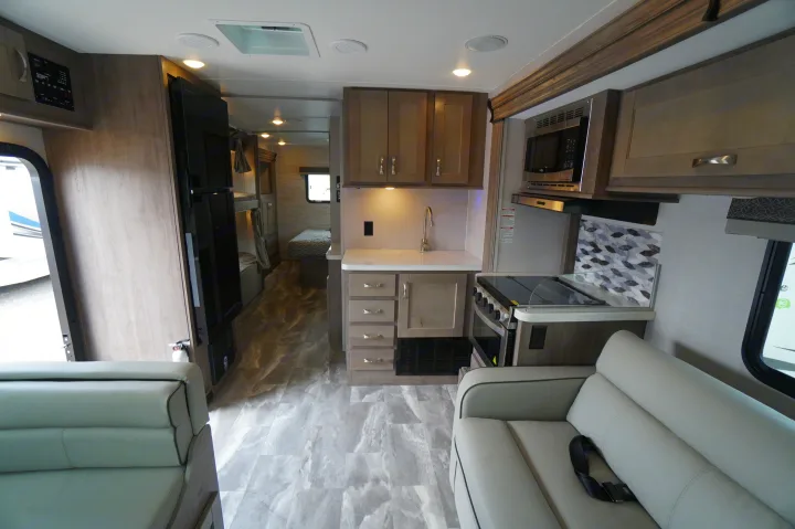Spacious RV rental interior: kitchen, living area, and back bedroom with bunk beds. Ideal for travel trailer adventures.. Gulf Stream Conquest 2024