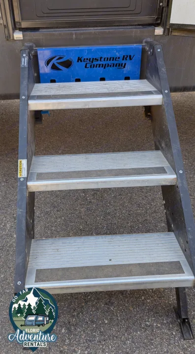 RV rental steps with Keystone RV Company branding. Sturdy and safe for your adventure travel.. Keystone RV Cougar 2021