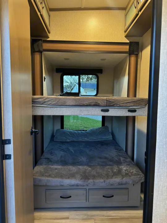 Comfortable RV rental bunk beds, featuring plush bedding, integrated storage, and scenic windows for your travels.. Coachmen Chaparral 2022