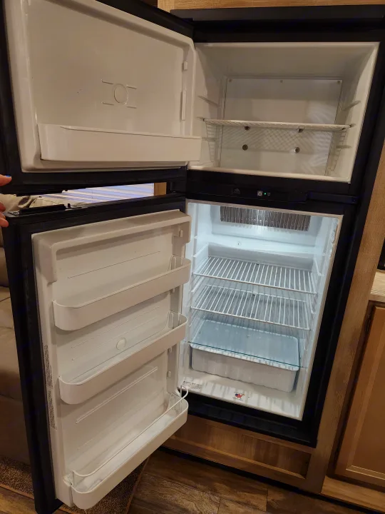 Clean, empty RV rental refrigerator and freezer, ready for your trip. Perfect for travel and camping adventures.. Coachmen Catalina 2020