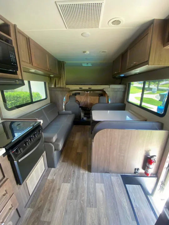 This RV rental's interior boasts a well-equipped kitchen, cozy dinette, and lounge, ready for your adventures.. Winnebago Minnie Winnie 2020