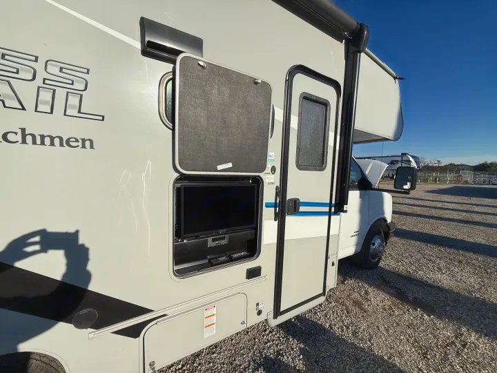 Side view of an RV rental showcasing its outdoor entertainment compartment with a TV and media controls. Ready for your next adventure!. 1HAGGUC78MN008793 Cross Trail 2022