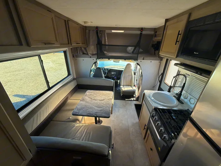 Spacious RV rental interior featuring a kitchen, dining area, and overhead bunk for comfortable travel.. 1HAGGUC78MN008793 Cross Trail 2022