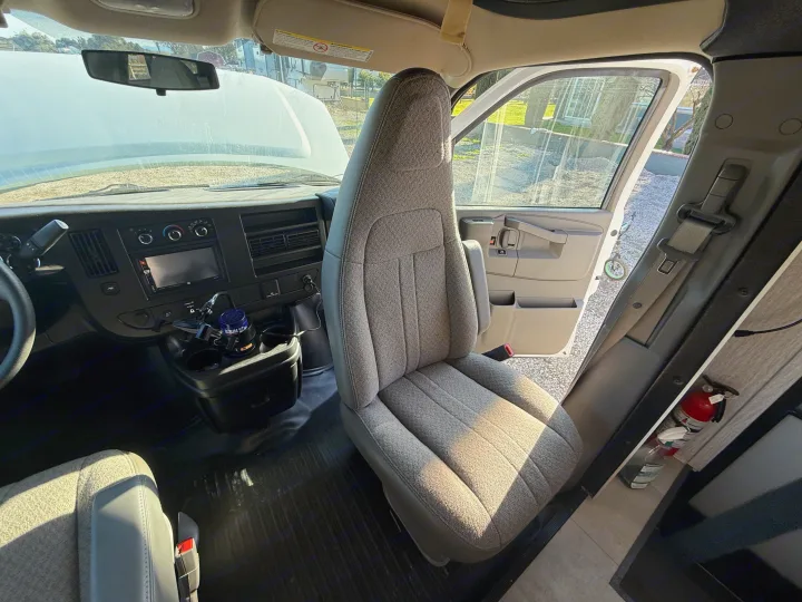 Inside an RV rental: view of dashboard, front passenger seat, open hood, and fire extinguisher near door.. 1HAGGUC78MN008793 Cross Trail 2022