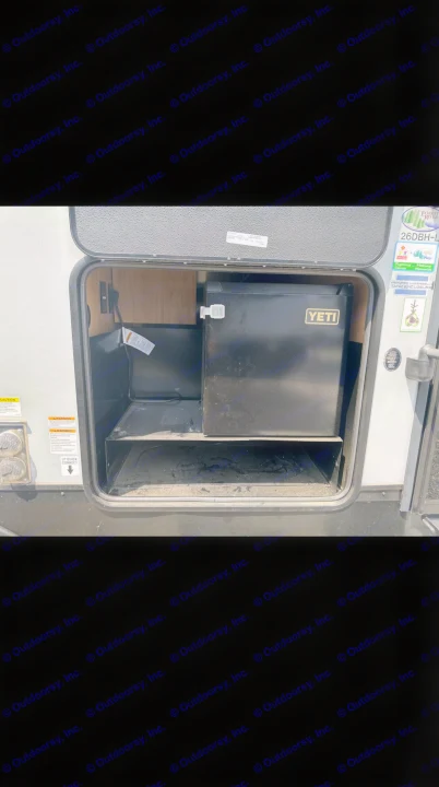 RV rental with outdoor amenities: portable Yeti fridge in an exterior compartment, perfect for camping adventures.. Forest River Cherokee Alpha Wolf 2023