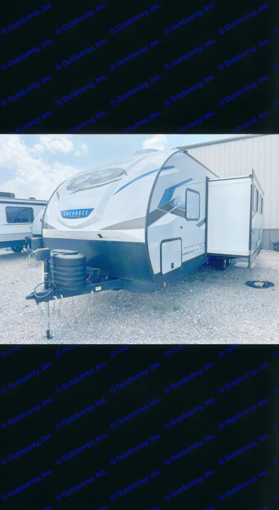 Spacious grey & blue Cherokee Alpha Wolf RV rental travel trailer with slide-out extended, ready for adventure.. Forest River Cherokee Alpha Wolf 2023