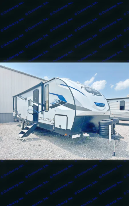 Sleek white and blue travel trailer, an Alpha Wolf Cherokee model, ideal for your next RV rental adventure.. Forest River Cherokee Alpha Wolf 2023