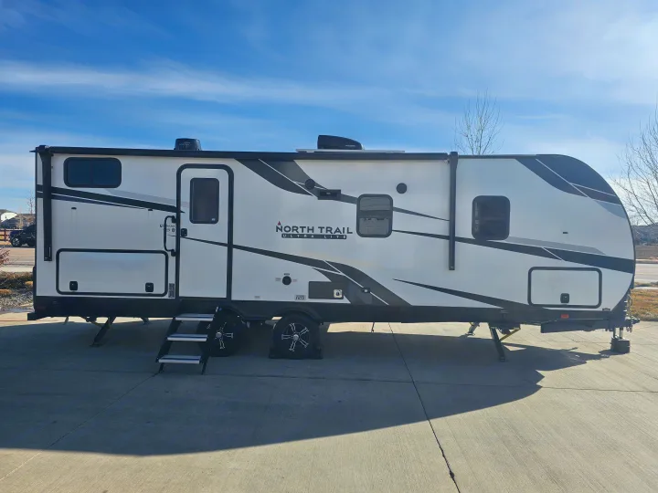 Explore with this North Trail Ultra Lite travel trailer RV, ideal for your next RV rental. Parked on concrete.. Heartland RVs North Trail 2024