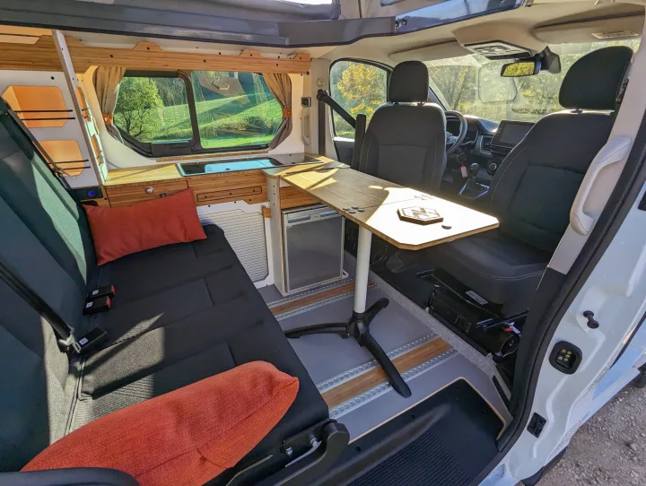 Cozy rv rental camper van interior: kitchenette, seating, table, and scenic views. Ideal for travel & adventure.. Renault Trafic 2025