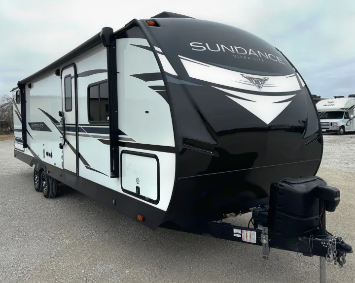 Modern white and black Sundance Ultra Lite travel trailer. An ideal RV rental for your next road trip adventure.. Heartland Sundance 2023