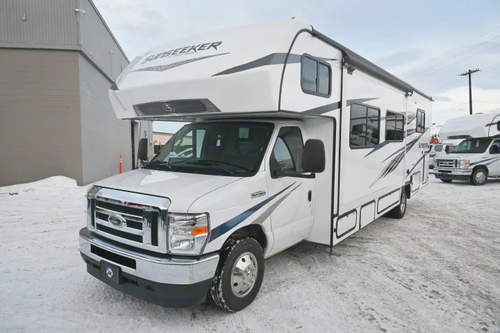 White Sunseeker Class C RV rental parked on a snowy lot, ready for winter trips.. Forest River Sunseeker - LE Series M-2850S 2024