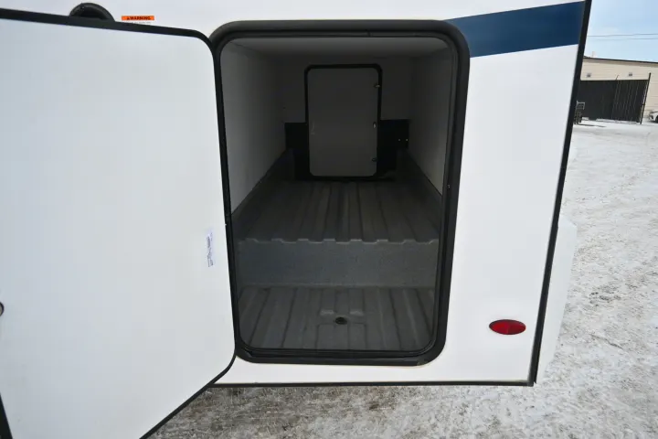Open RV rental storage compartment. Spacious, ribbed interior with a secondary access door, perfect for gear.. Forest River Sunseeker - LE Series M-2850S 2024