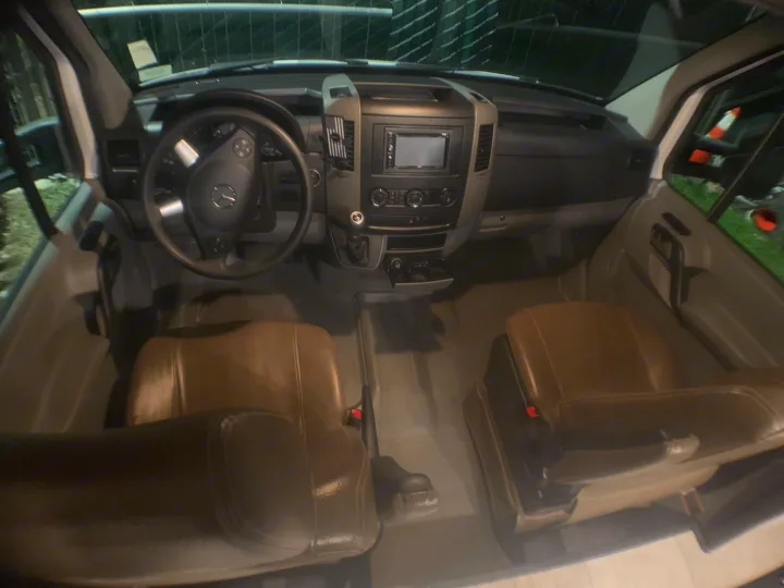 Explore this RV rental's spacious front cabin, featuring a Mercedes-Benz steering wheel, dashboard, and tan seats.. Coachmen Prism 2022