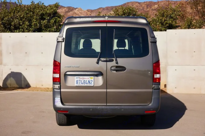 Rear view of a tan PeaceVans Modern Mercedes-Benz Metris camper van, an excellent option for rv rental adventures.. Mercedes-Benz Metris 2018