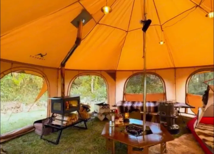 This inviting glamping tent, boasting a wood stove and comfortable interior, offers a luxurious outdoor stay perfect for your RV rental trip.. Ford Custom Transit 2016