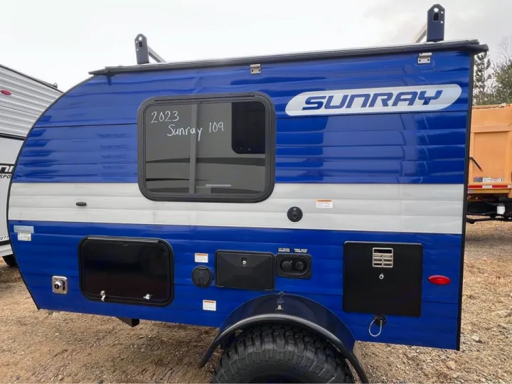 Blue & white 2023 Sunray 109 travel trailer, ideal for rv rental. Compact RV with off-road tires.. Sunset Park RV SunRay 2023