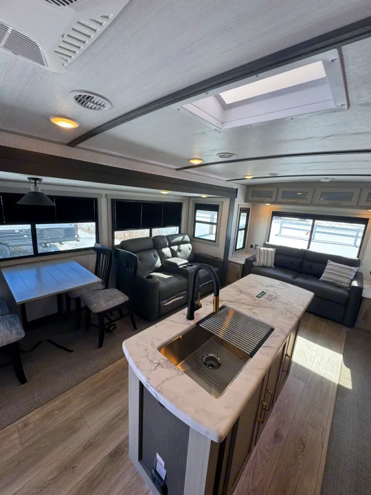 Spacious, modern RV rental interior featuring kitchen island, dining table, and comfortable seating areas.. Forest River Salem Hemisphere 2024