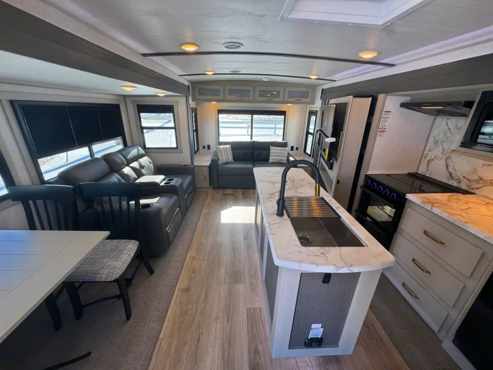 Explore this modern RV rental interior with a kitchen island, comfortable living area, and dining space.. Forest River Salem Hemisphere 2024