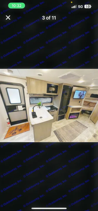 Modern rv rental interior: kitchen with sink & stove, TV/fireplace living area, bunk beds, and exit door visible.. Dutchmen Kodiak SE 2024