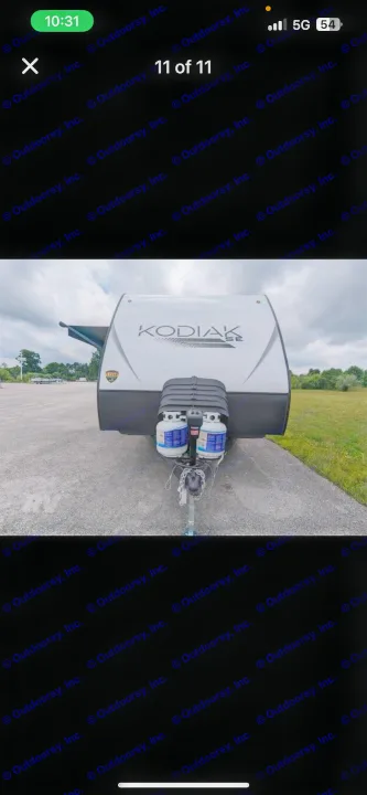 Front of a white Kodiak SE travel trailer with propane tanks, ideal for an RV rental adventure.. Dutchmen Kodiak SE 2024