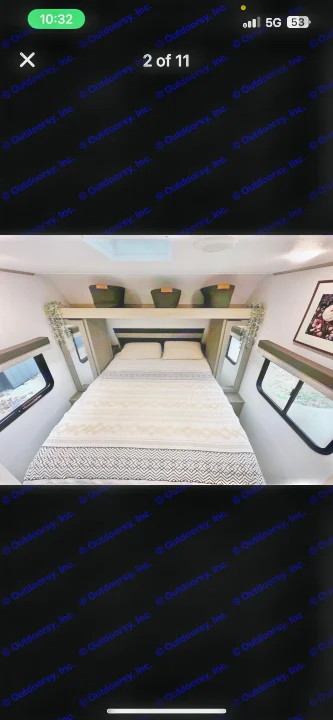 Bright RV rental bedroom: Features a patterned bed, overhead storage, and side windows.. Dutchmen Kodiak SE 2024