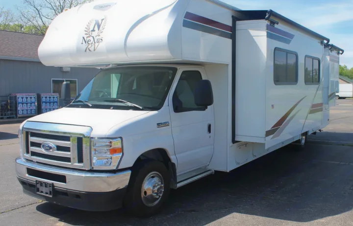 White Nexus RV rental, a Class C motorhome on Ford E-450 chassis with a deployed slide-out.. Nexus RV Triumph 2021